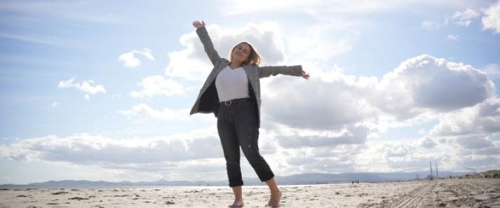 Student on the beach feeling free